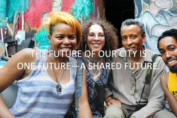 Image text: The future of our city is one future — a shared future. Shows a multiethnic group in front of a mural.
