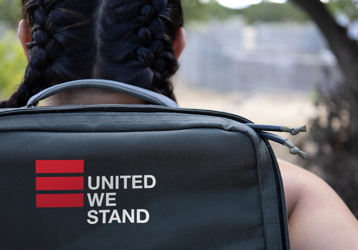 back of woman with backpack with OH United We Stand logo